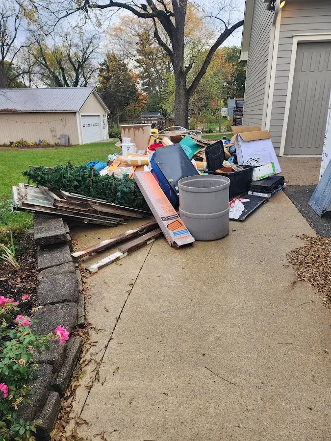 Dumpster being loaded with debris for 12 Yard Dumpster Rental in Chippewa